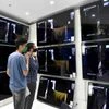 Customers look for electronic appliances at a Kohinoor electronic Showroom after the shops were allowed to re-open with strict guidelines, in Borivali on Tuesday.