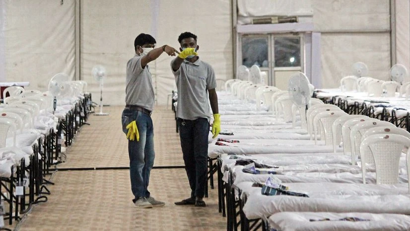 Quarantine center Workers while preparing the makeshift quarantine center for COVID-19 patients, in Mumbai on Saturday.