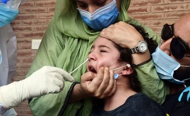 Compromised Covid behaviour biggest reason for surge in cases: RML Director A health official takes a swab sample of a child who returned from Pakistan at a Covid-19 coronavirus testing centre in Srinagar