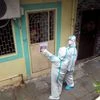 Health workers wear protective gear on their way to take health details of the residents of a 'containment zones' at the Kajupada area in Mumbai