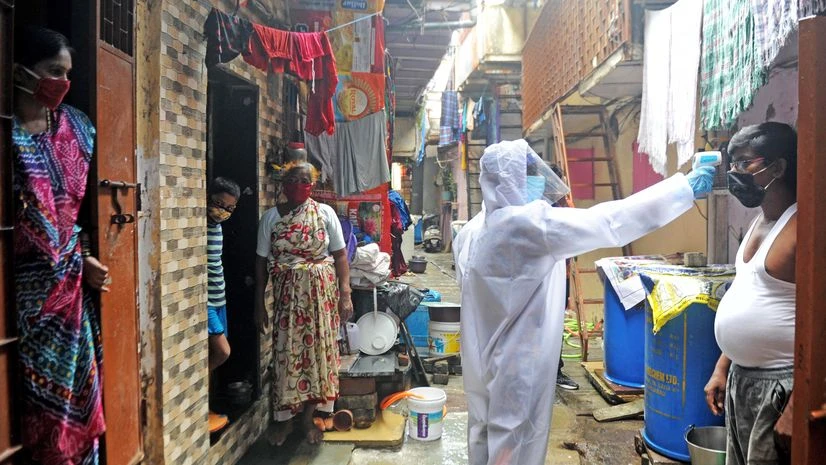 Coronavirus, medical staff Healthcare workers screening the body temperature of people during a door-to-door survey for Covid-19 in Mumbai.