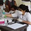 Health workers conduct the Covid-19 rapid antigen testing at Bhim Nagar, in Gurugram.