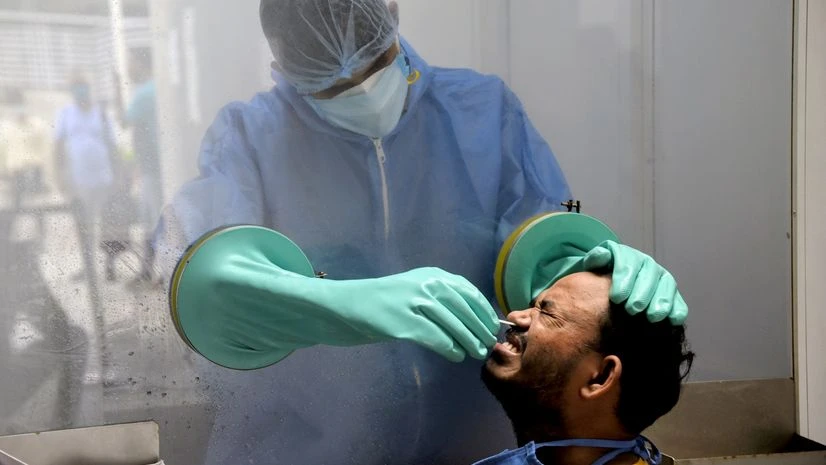 Coronavirus Health worker collects nasal sample from a man for Covid-19 test, in New Delhi.