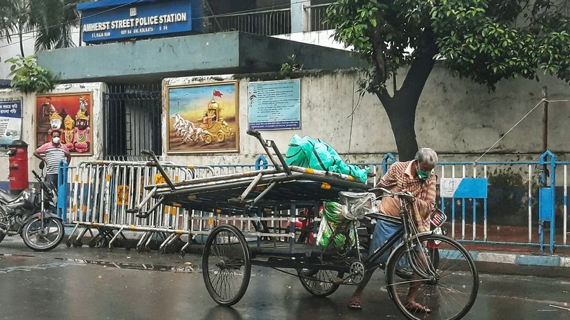 rain, rainfall A rickshaw puller carries barricade in his cart during a rainfall, in Kolkata on Thursday. Photo: ANI
