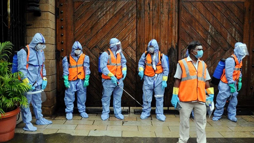BMC Workers wearing PPE suit BMC Workers wearing PPE suit gear up for sanitization at the Veteran actor Amitabh Bachchan residence's Jalsa, after he and his son Abhishek Bachchan tested positive for COVID-19, in Mumbai on Sunday.