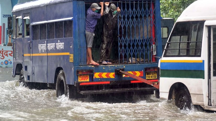Mumbai rain Vehicles moving on a waterlogged road due to heavy rain at Hindmata Dadar, in Mumbai on Wednesday.