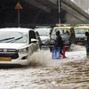 Vehicles pass through a waterlogged road during a rain, in Mumbai on Wednesday.