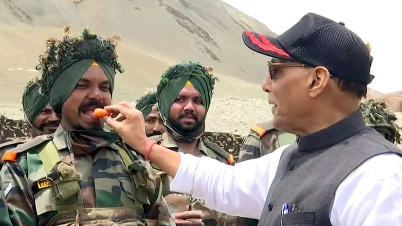 Defence Minister Rajnath Singh Defence Minister Rajnath Singh offers sweet to Indian Army personnel at Lukung in Leh on Friday.