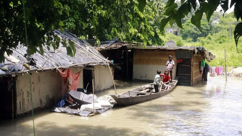 Floods Children take shelter on a boat after their house is partially submerged under floodwaters in a flooded area at Sonitpur, in Guwahati on Sunday.