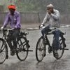 Commuters on road during heavy rainfall, in New Delhi