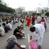 Volunteers serve food among needy people during the total lockdown in the wake of coronavirus pandemic in Patna.