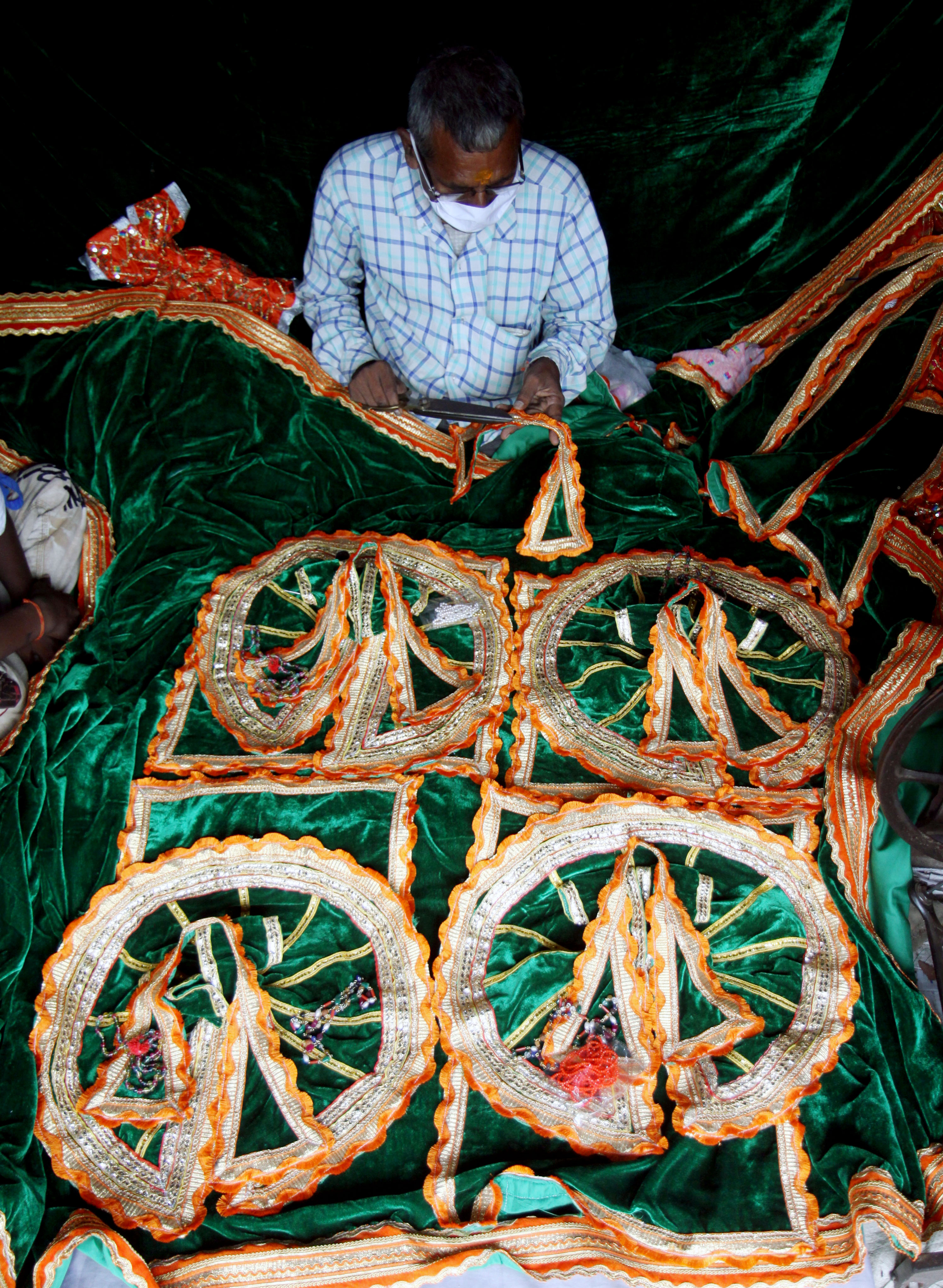 Tailor Bhagwat Prasad preparing the clothes which will be used on 5th August in Ayodhya Tailor Bhagwat Prasad preparing the clothes which will be used on 5th August in Ayodhya