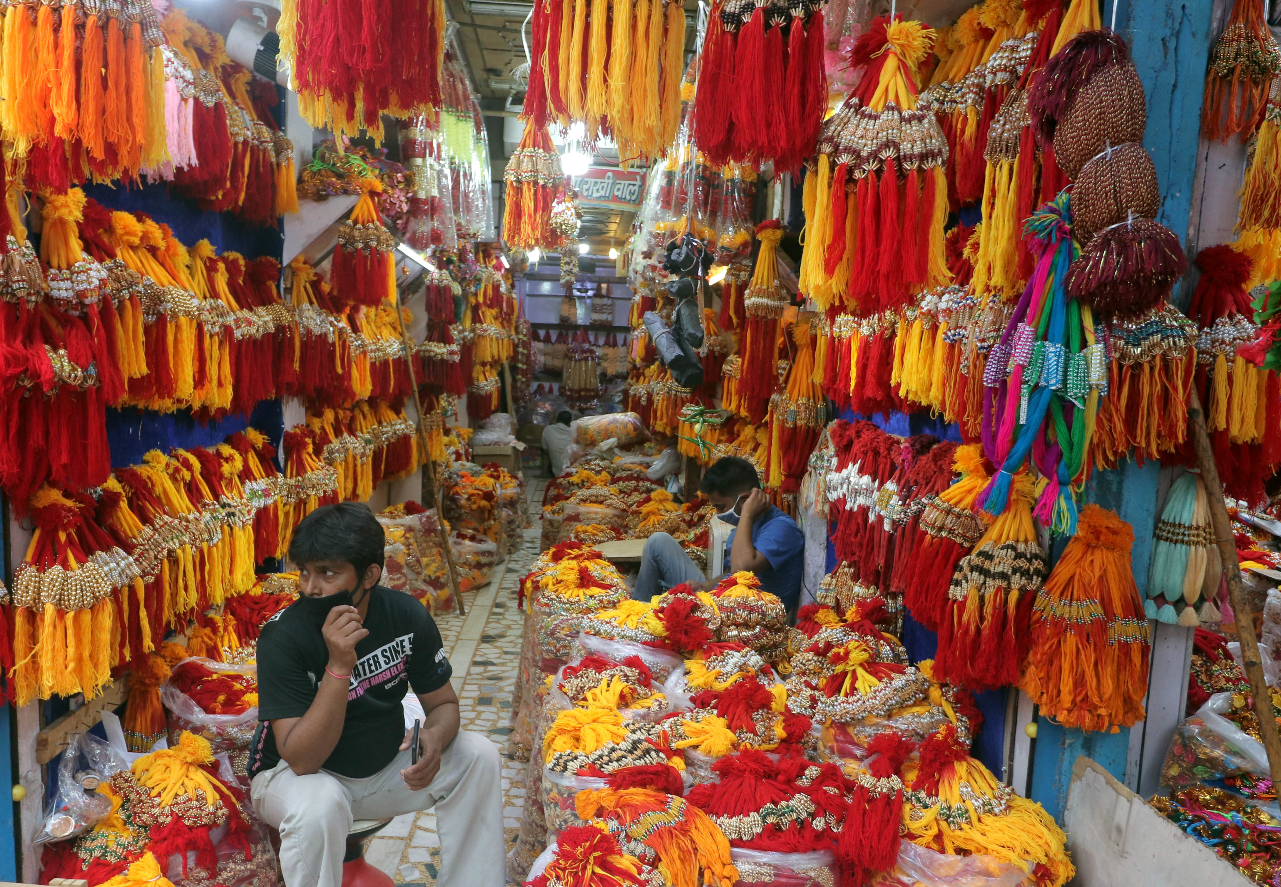 A shopkeeper waits for customers to buy rakhi ahead of Rakshabandhan, in New Delhi A shopkeeper waits for customers to buy rakhi ahead of Rakshabandhan, in New Delhi