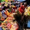 People purchasing decorative goods and idol of Lord Krishna on the eve of Janmashtami festival, in Varanasi on Tuesday.