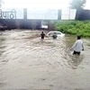 Commuters stuck in overflowing water at an underbridge during heavy rainfall at Habibganj in Bhopal on Saturday.