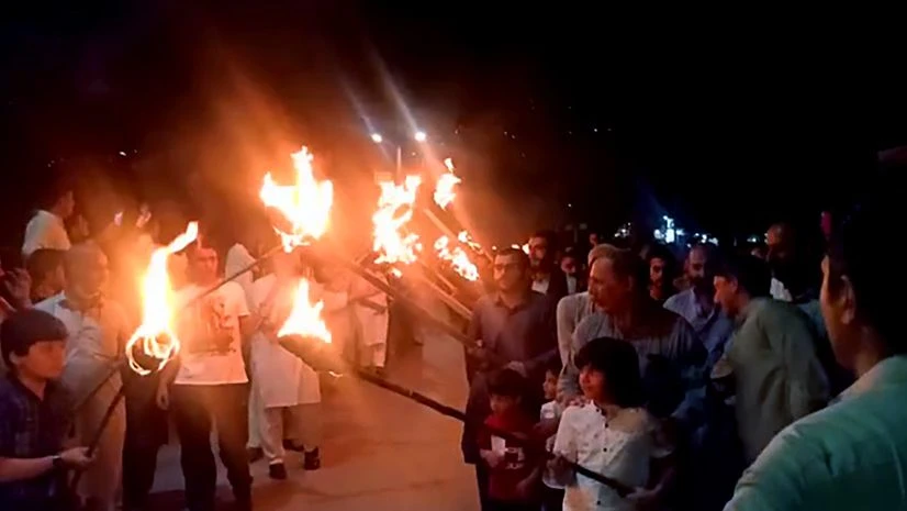Pakistan occupied Kashmir, PoK People raise slogans "Neelum-Jhelum behne do, humein zinda rehne do" and hold torch rally during a protest to oppose the mega dams to be constructed by Chinese firms on Neelum-Jhelum River, in Muzaffarabad city of Pakistan occupied Kashmir.