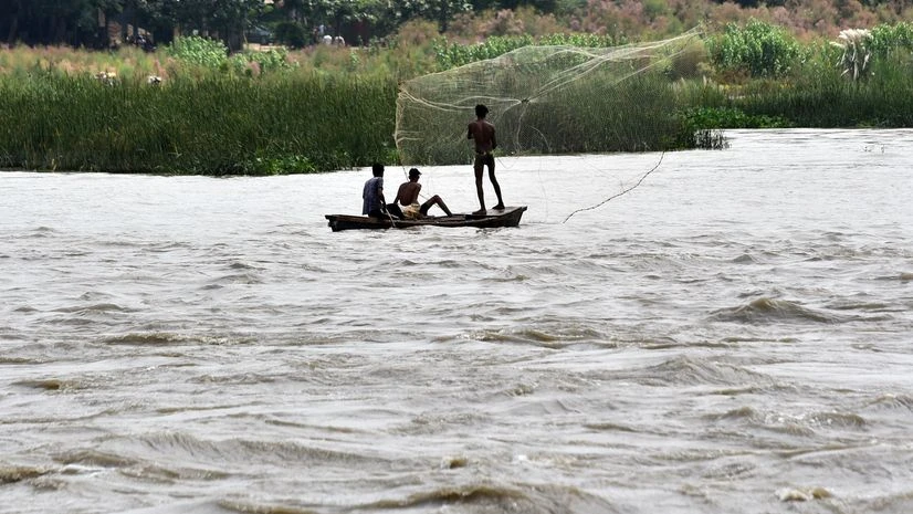 Yamuna Fishermen throw the fishing net as the water level of the Yamuna river rises following rains over the past several days in Delhi.