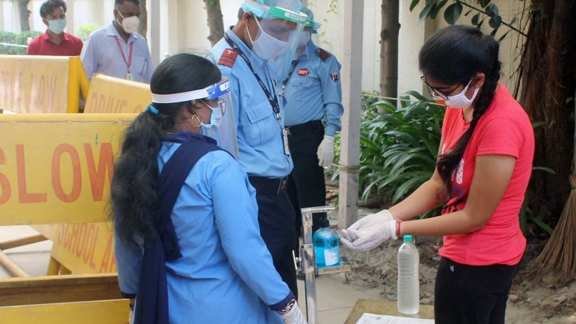 Student undergoes thermal screening before entering an examination centre to appear for National Eligibility cum Entrance Test (NEET) 2020 entrance papers, amid the ongoing coronavirus pandemic, at Sector 14, in Gurugram on Sunday. Coronavirus
