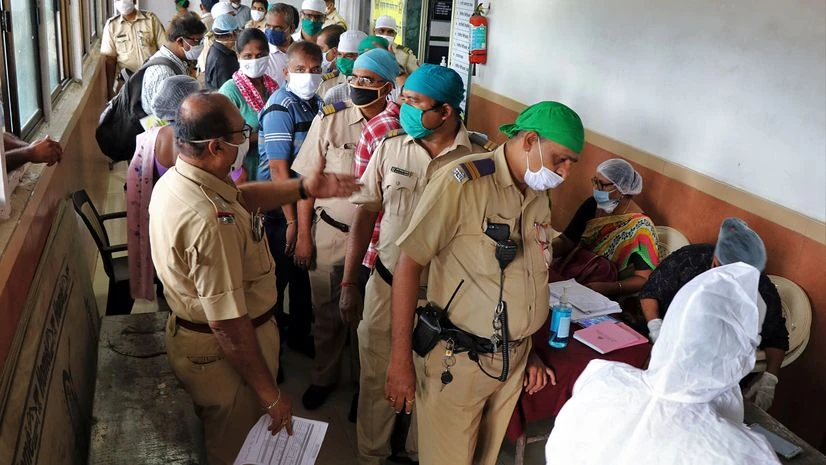 coronavirus A healthcare worker wearing personal protective equipment(PPE) collects a nasal sample from a policeman, during a check-up campaign for the coronavirus disease (COVID-19) set up inside a police station, in Mumbai.