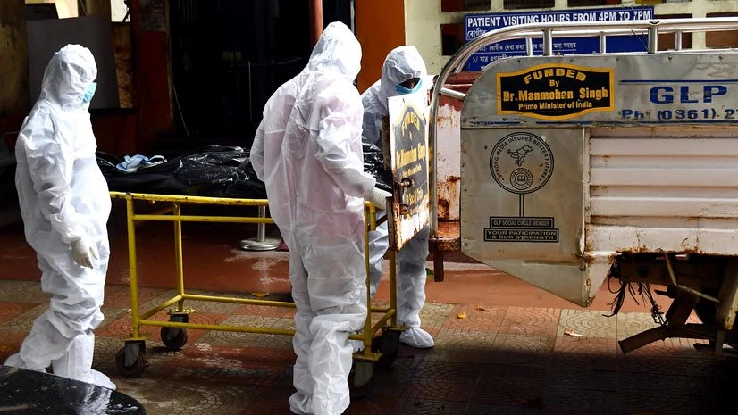coronavirus Health workers in Personal Protective Equipment (PPE) kit taking a dead body for the cremation of a patient who died from Covid-19 coronavirus at Mahendra Mohan Choudhury Hospital in Guwahati.