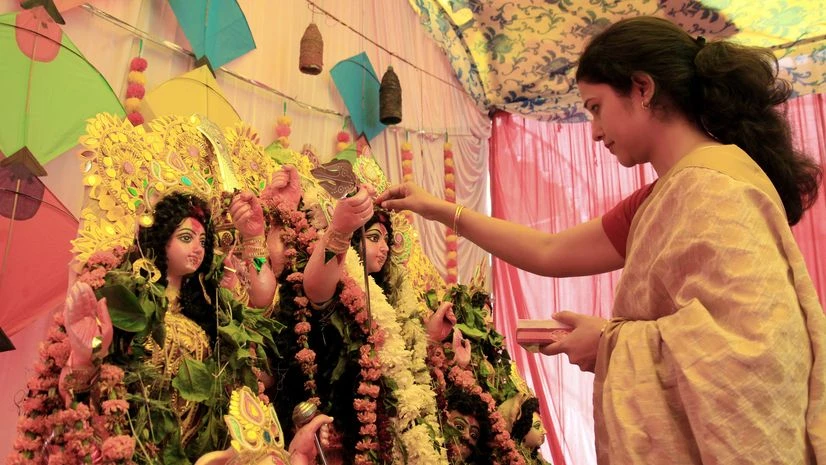 A Bengali woman offers a prayer to the idol of Goddess Durga as she participates in 'sindoor khela' on the occasion of Vijayadashami at a puja pandal in Lucknow on Monday. A Bengali woman offers a prayer to the idol of Goddess Durga as she participates in 'sindoor khela' on the occasion of Vijayadashami at a puja pandal in Lucknow on Monday.