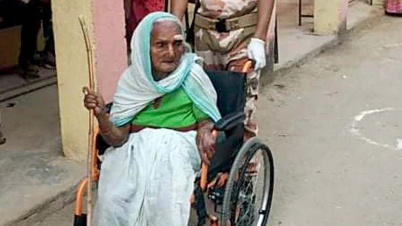 Bihar Assembly polls ITBP personnel helps an specially abled woman as she arrives to cast her vote for the first phase of Bihar Assembly polls, in Nawada District on Wednesday.
