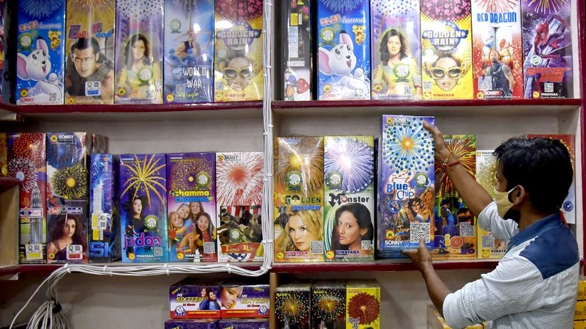 Diwali, Delhi A vendor waits for customers as he sells green crackers ahead of Diwali Festival in Old Delhi on Friday.