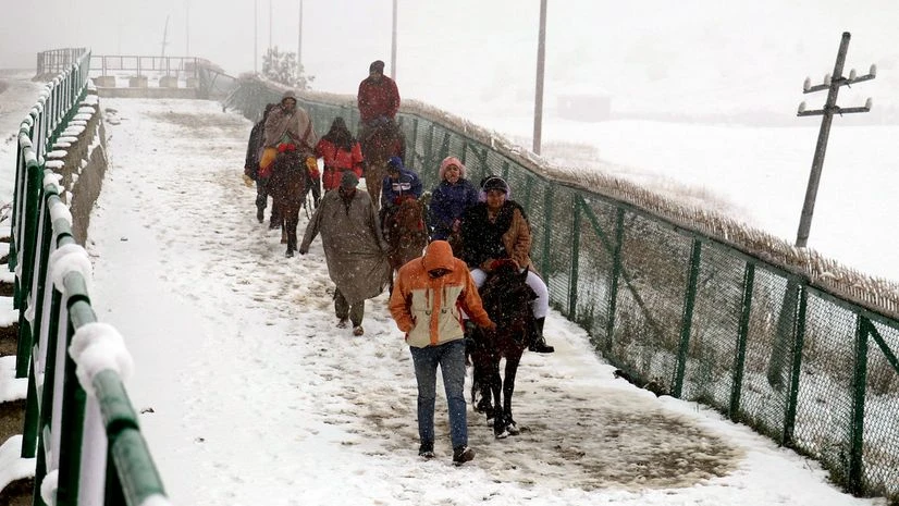 Snowfall, Kashmir Tourists take horse rides to enjoys as Kashmir valley received the first snowfall of the season in upper reaches in north Kashmir's Baramulla district on Saturday.