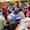 People from Bihar and Uttar Pradesh wait at Anand Vihar railway station while going back to their home states on the occasion of Chhath puja, in New Delhi on Tuesday.