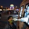 Health workers collecting swab samples from a person for COVID-19 testing at India Gate in New Delhi on Sunday.