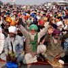 Farmers raise slogans during a protest against the farm laws at Singhu border in New Delhi on Tuesday.