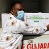 A worker unloads COVISHIELD vaccine consignment from Serum Institute of India as it arrives at the Cold storage facility at Civil Hospital, ahead of the rollout of the vaccination program, in Ahmedabad on Tuesday.