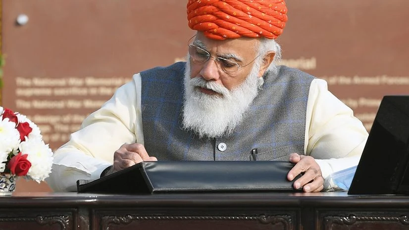 Prime Minister Narendra Modi signing the visitor's book at the National War Memorial, on the occasion of the 72nd Republic Day Parade 2021 Prime Minister Narendra Modi signing the visitor's book at the National War Memorial, on the occasion of the 72nd Republic Day Parade 2021