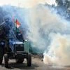 Police personnel fire tear gas shells as protesting framers create chaos during tractor rally at ring road in New Delhi