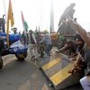 Farmers' break the barriers after breaching the routes during their Tractor rally at Ghazipur Border in New Delhi