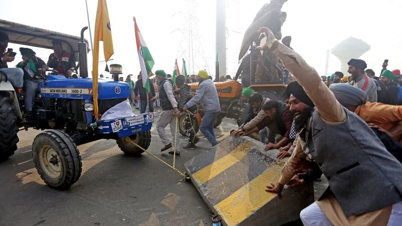 Farmers' break the barriers after breaching the routes during their Tractor rally at Ghazipur Border in New Delhi Farmers' break the barriers after breaching the routes during their Tractor rally at Ghazipur Border in New Delhi