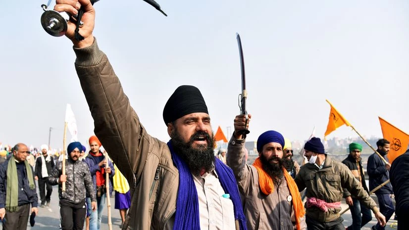 Farmers' shout slogans during their Tractor rally against the new farm laws at Mukarba Chowk near Singhu border in New Delhi Farmers' shout slogans during their Tractor rally against the new farm laws at Mukarba Chowk near Singhu border in New Delhi