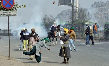 SP, BSP demand repeal of 3 new farm laws after Delhi tractor rally Protesting farmers pelting stones during their Tractor rally against the new farm laws at Mukarba Chowk near Singhu border in New Delhi