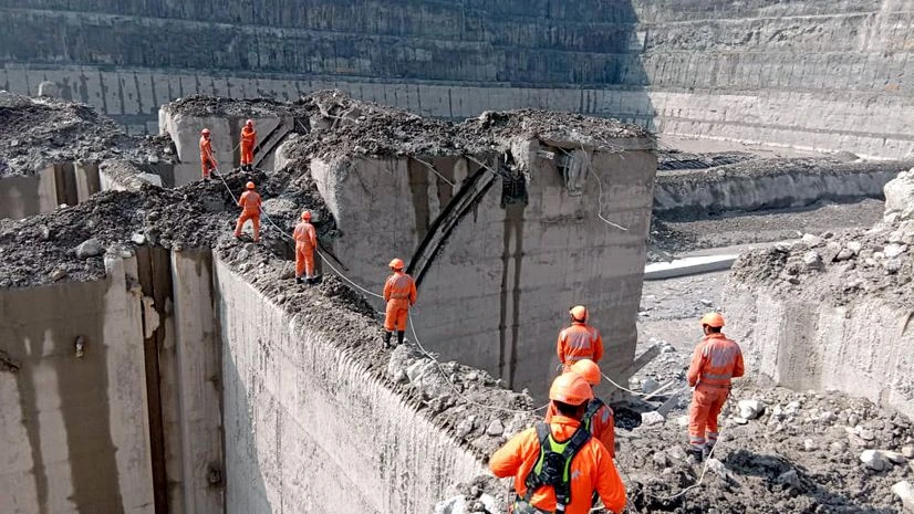 NDRF team search at barrage as rescue operations continue, in Chamoli district on Sunday. NDRF team search at barrage as rescue operations continue, in Chamoli district on Sunday.