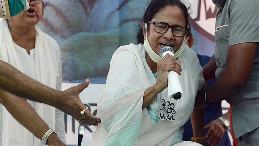 West Bengal CM Mamata Banerjee tries to stand up while reciting National Anthem during an Election Campaigning, in Nandigram on Tuesday. West Bengal CM Mamata Banerjee tries to stand up while reciting National Anthem during an Election Campaigning, in Nandigram on Tuesday.