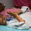 An elderly COVID-19 patient takes breathe with the support of an oxygen cylinder provided for free by Indirapuram Gurudwara amid a shortage of Oxygen gases, in Ghaziabad on Sunday.