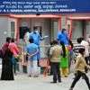 Family members of COVID-19 patients stand outside ICU ward at K C General Hospital in Bengaluru on Thursday.