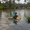 A boy rides on a makeshift boat on waterlogged street aftermath of cyclone Yaas, at Kultali in South 24 Parganas on Thursday.