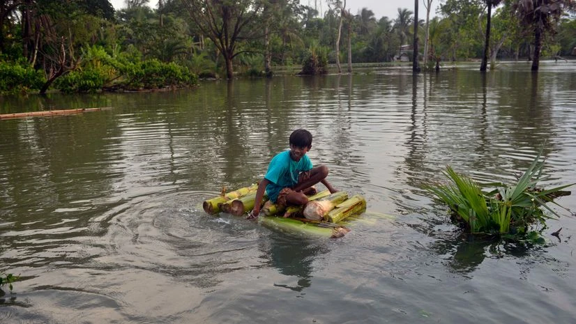 A boy rides on a makeshift boat on waterlogged street aftermath of cyclone Yaas, at Kultali in South 24 Parganas on Thursday. A boy rides on a makeshift boat on waterlogged street aftermath of cyclone Yaas, at Kultali in South 24 Parganas on Thursday.