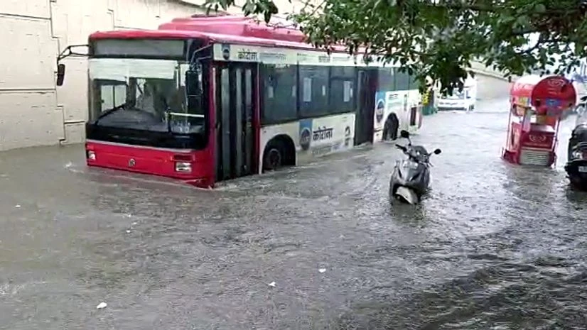 Delhi rain Vehicles ply on a waterlogged road after rainfall, in New Delhi on Tuesday.