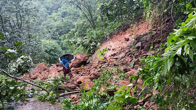 Kerala flood A man walks over debris triggered by a landslide at a flood-affected area, at Meloram village, in Kottayam. Photo: ANI