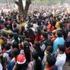People gather outside St Paul's Cathedral Church to celebrate the Christmas festival, in Kolkata.