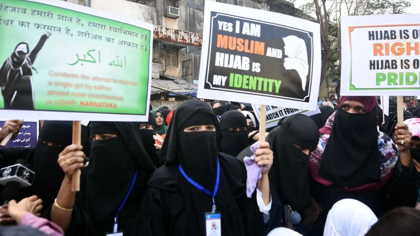 hijab ban, Karnataka Hijab row Women hold placards as they stage a protest against the ban on 'Hijab' imposed in few colleges in Karnataka, in Mumbai on Sunday.