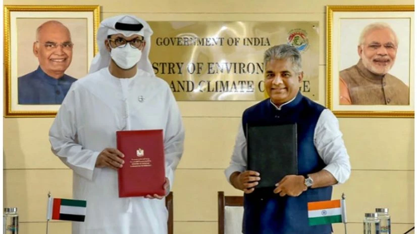 Sultan Al Jaber( L) Bhupender Yadav (R) **EDS: HANDOUT PHOTO MADE AVAILABLE FROM PIB ON THURSDAY, MAY 26, 2022** New Delhi: Union Minister for Environment, Forest & Climate Change Bhupender Yadav signs an MoU on climate action with UAE Minister of Climate Envoy, Industry and Advanced Techn