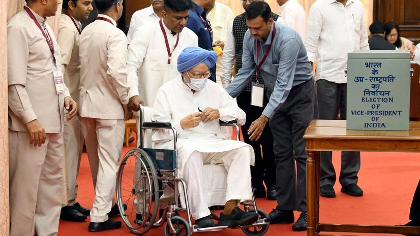 Former Prime Minister Manmohan Singh being assisted as he arrives in a wheelchair to cast his vote for the Vice Presidential election at Parliament, in New Delhi on Saturday. (Photo: ANI) Former Prime Minister Manmohan Singh being assisted as he arrives in a wheelchair to cast his vote for the Vice Presidential election at Parliament, in New Delhi on Saturday. (Photo: ANI)